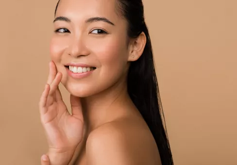 Woman with cosmetic powder smiling 