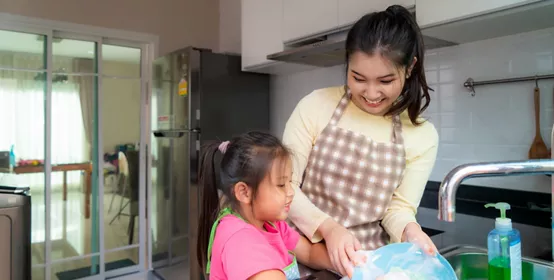 Mother and daughter doing dishes 