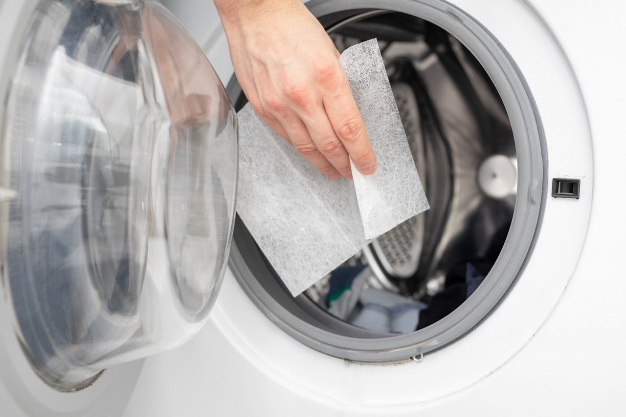 Dryer sheet going into a dryer