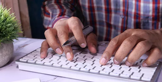 Closeup of person hand typing keyboard