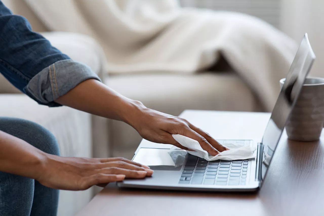 Sanitizing Laptop Keyboard with wet wipe 