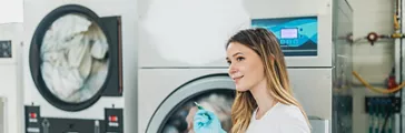 Female Worker Operating Industrial Washing Machines