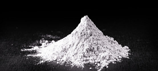 Titanium dioxide (TiO2) powder for cosmetics, isolated black background