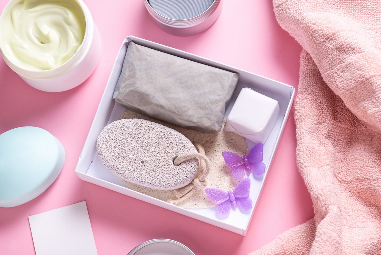 Set of bath tools and soap bars in cardboard box