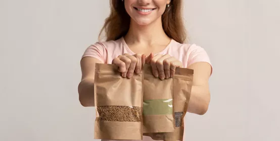 Person holding paper packages of food