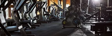 Well-lit gym full of various equipment for working out 