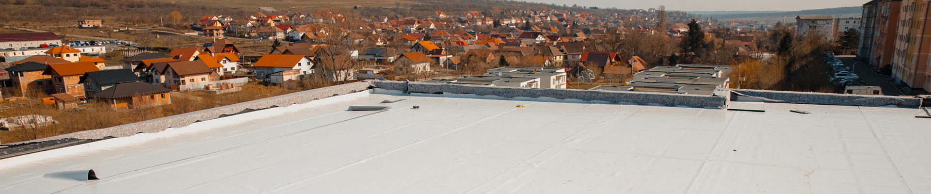 Flat roof with hot air welded PVC membrane waterproofing for ballasted system.