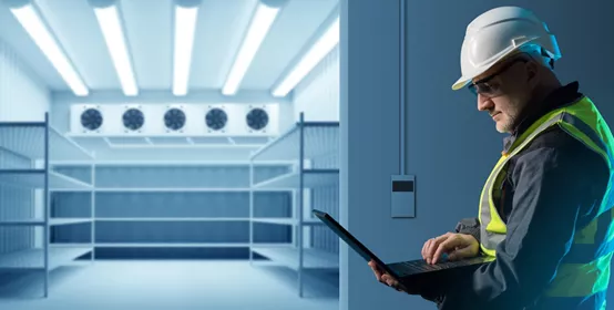 Male engineer on a computer setting up energy-efficient refrigeration equipment 