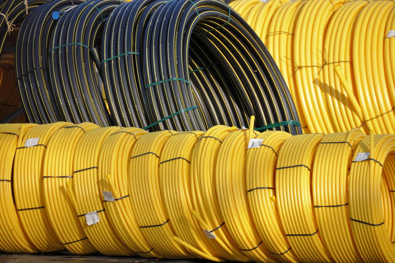 Stock black and yellow coiled plastic pipes