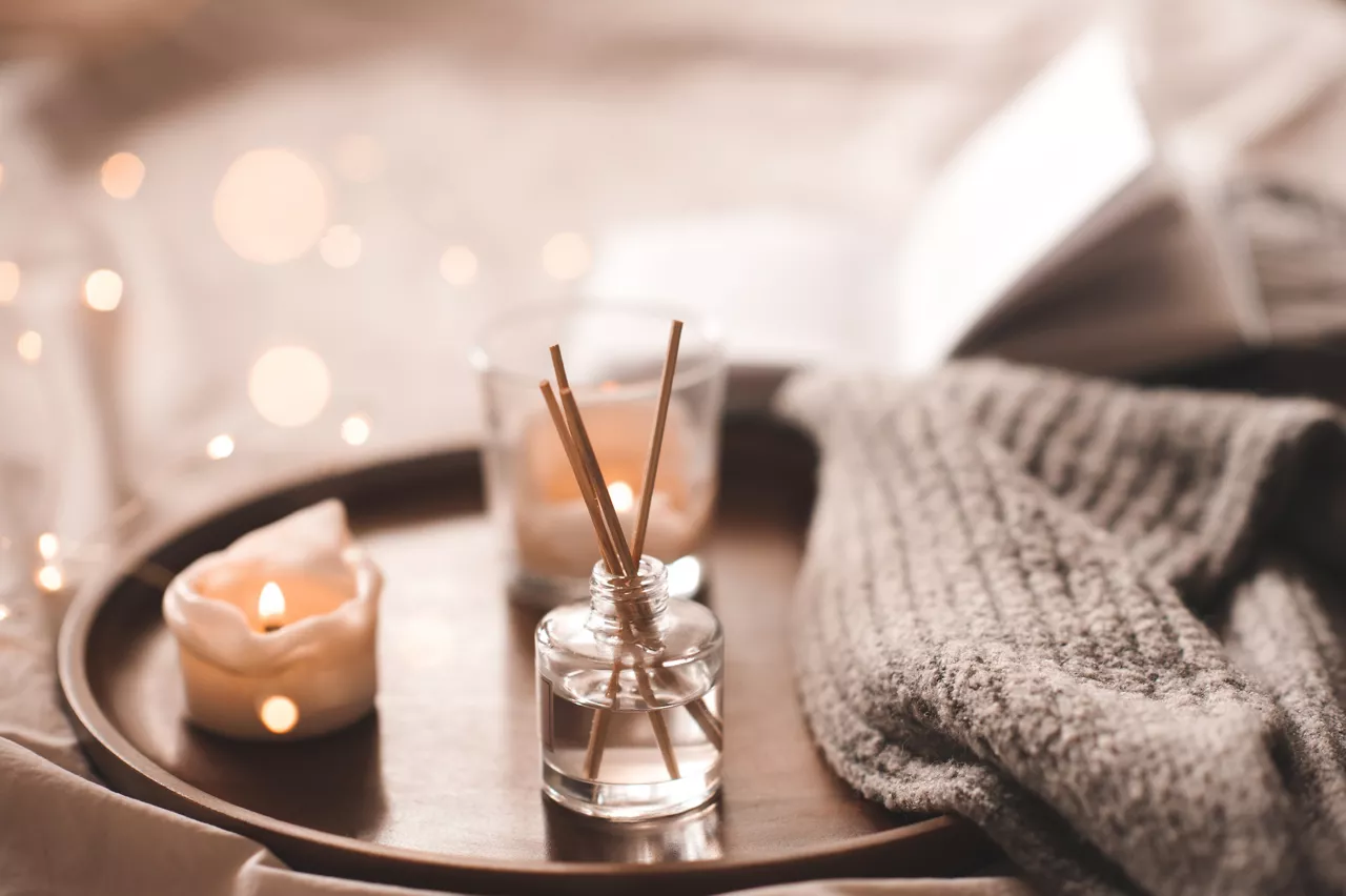 Home perfume in glass bottle with wood sticks