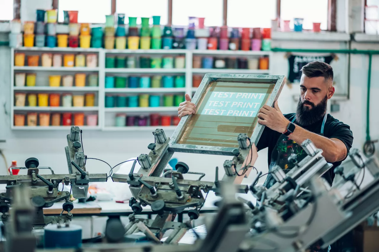 Male Worker Preparing Screen Printing Film