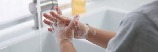 Boy washing hands with liquid soap over sink, closeup. Banner design