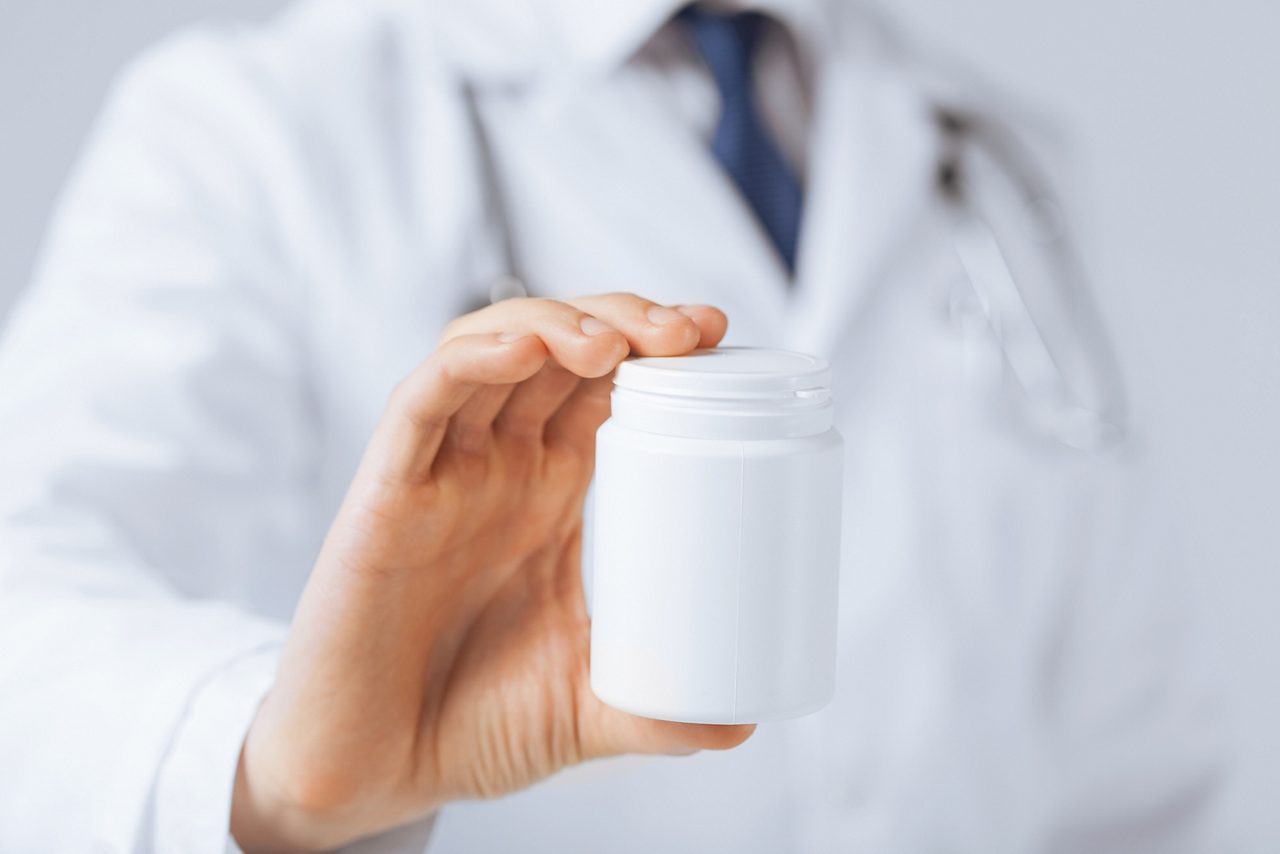 Doctor Holding Medicine Bottle