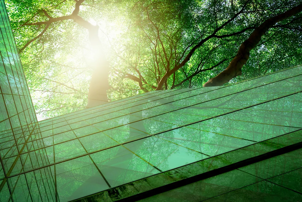 Glass office building with tree for reducing carbon dioxide