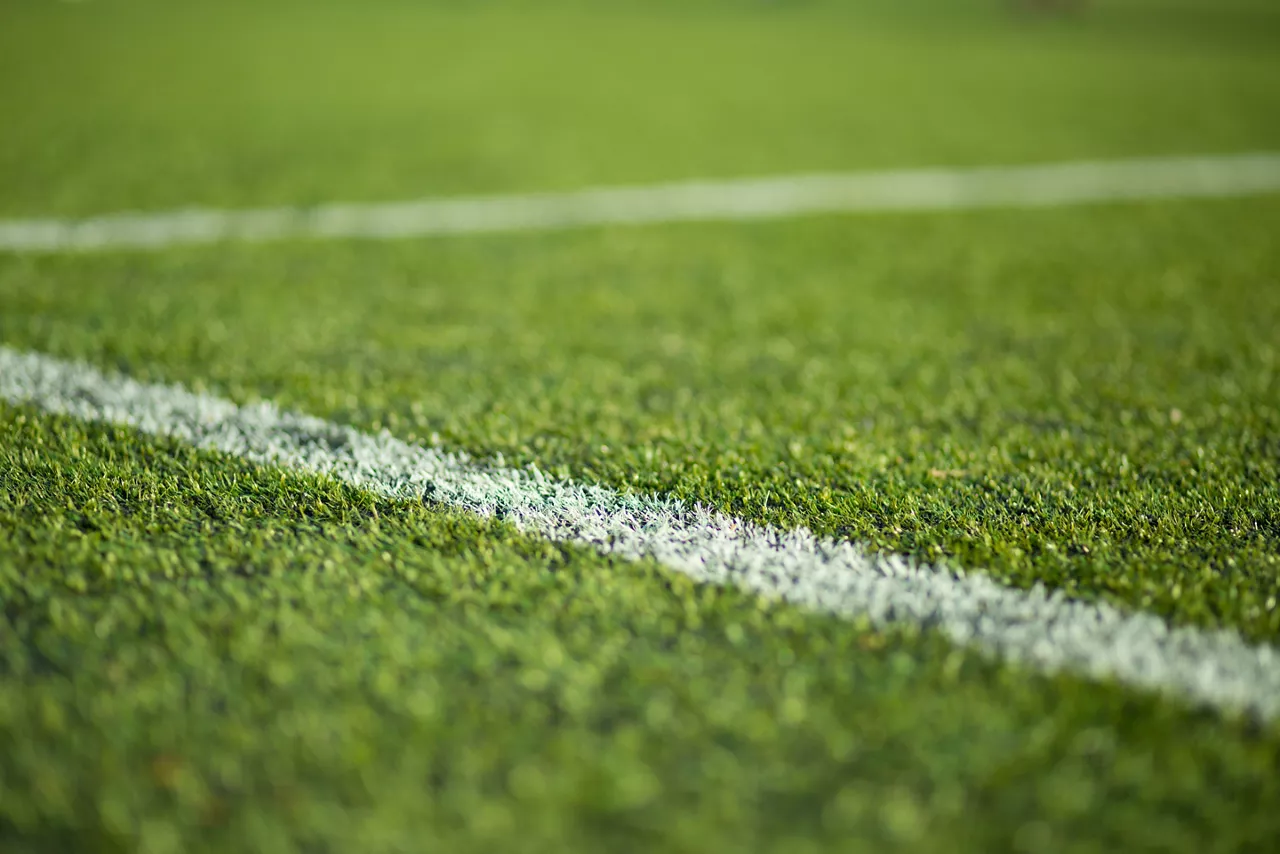 Close-up of green soccer pitch.