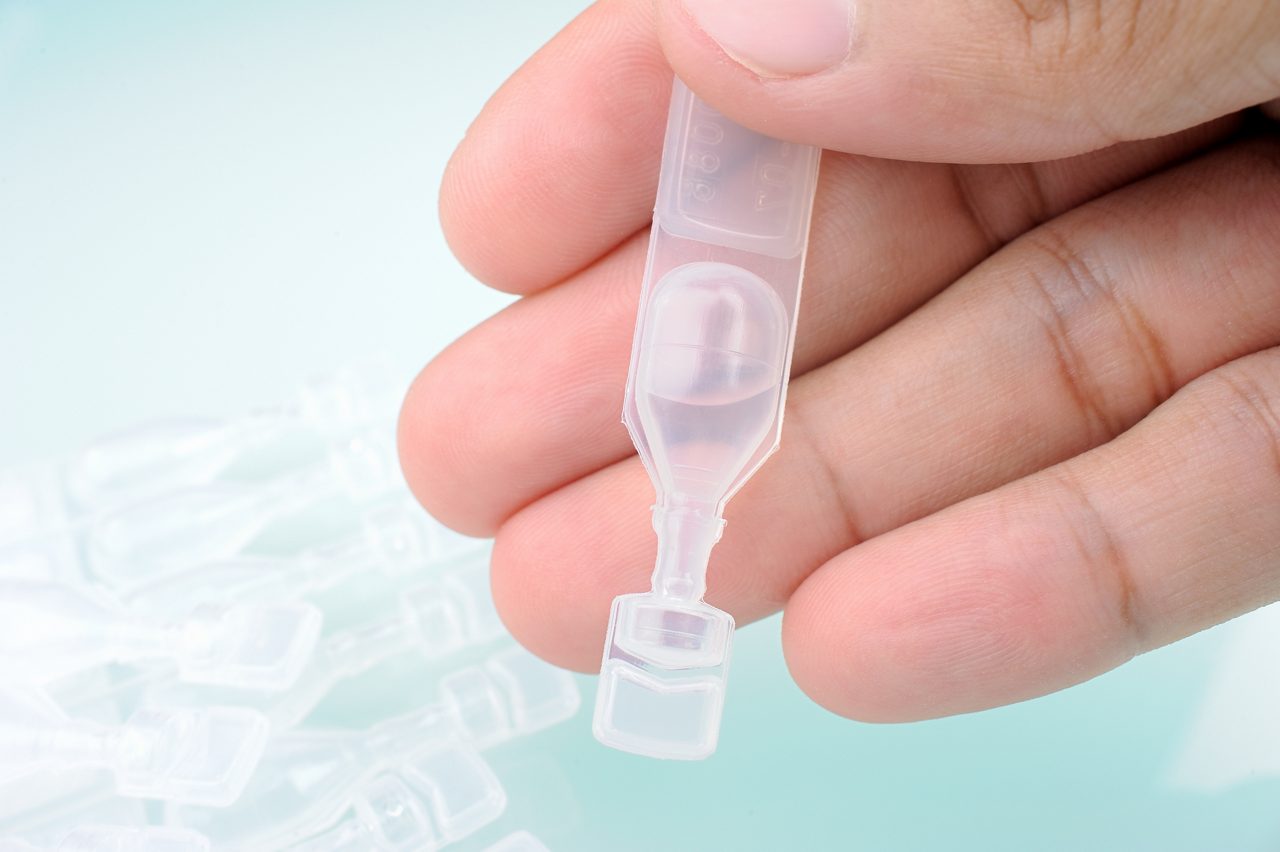 Clear ampoules on light blue background