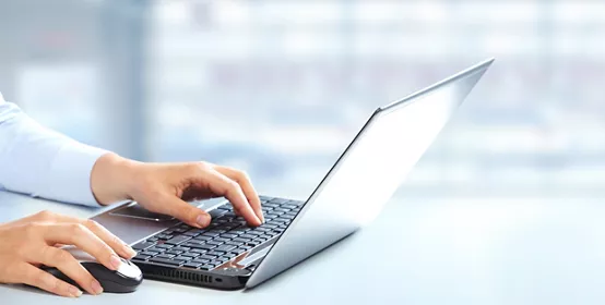 Hands of business woman typing on computer keyboard.