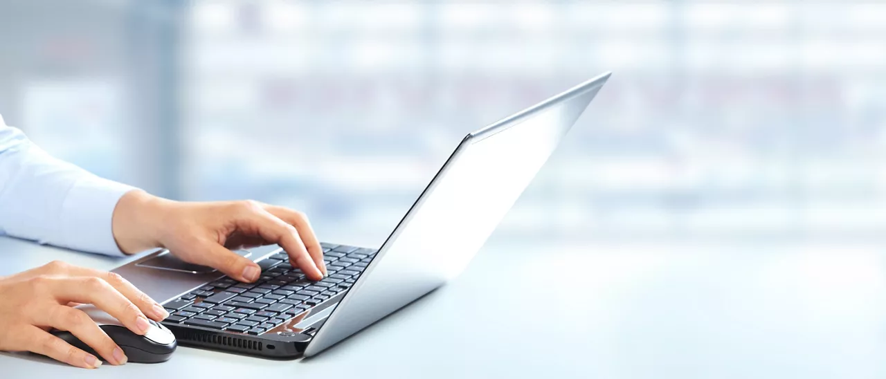 Hands of business woman typing on computer keyboard.