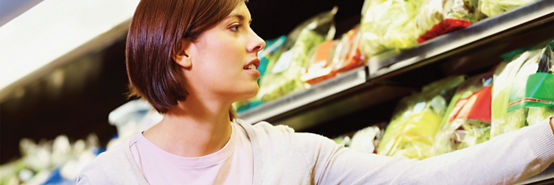 Woman reaching for grocery item 