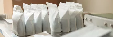 White stand up pouches on a desk