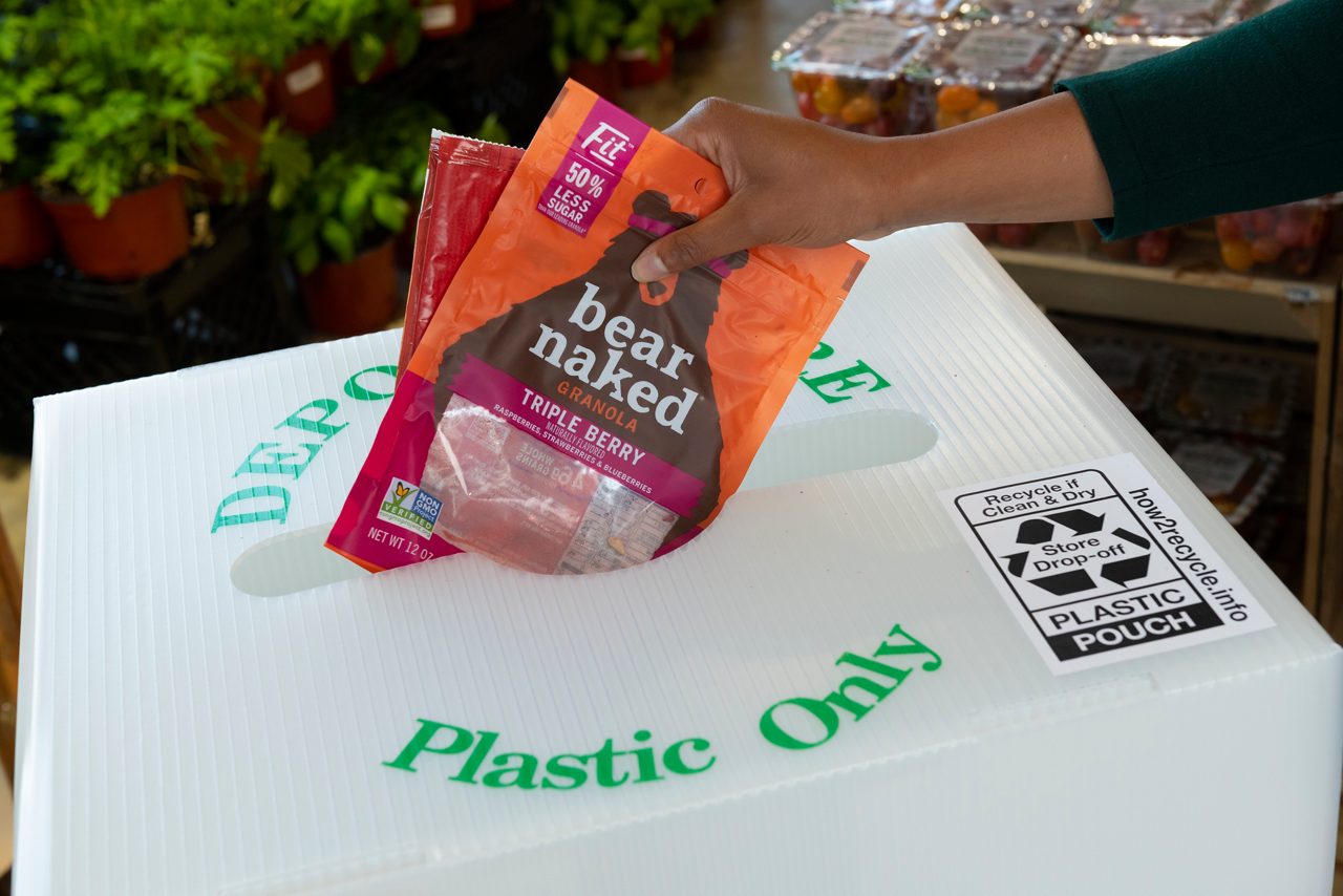 Bear naked plastic packaging being placed in a Plastic Only recycle bin