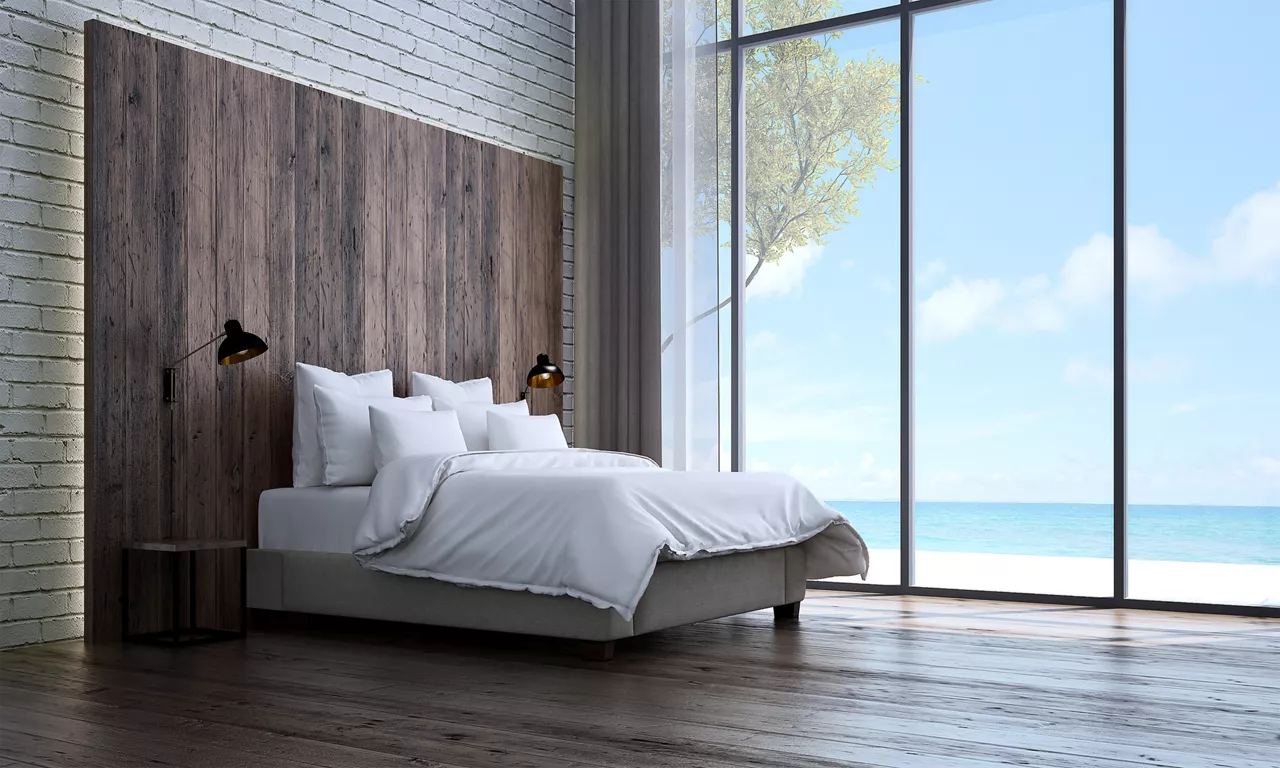 Bed against wooden wall