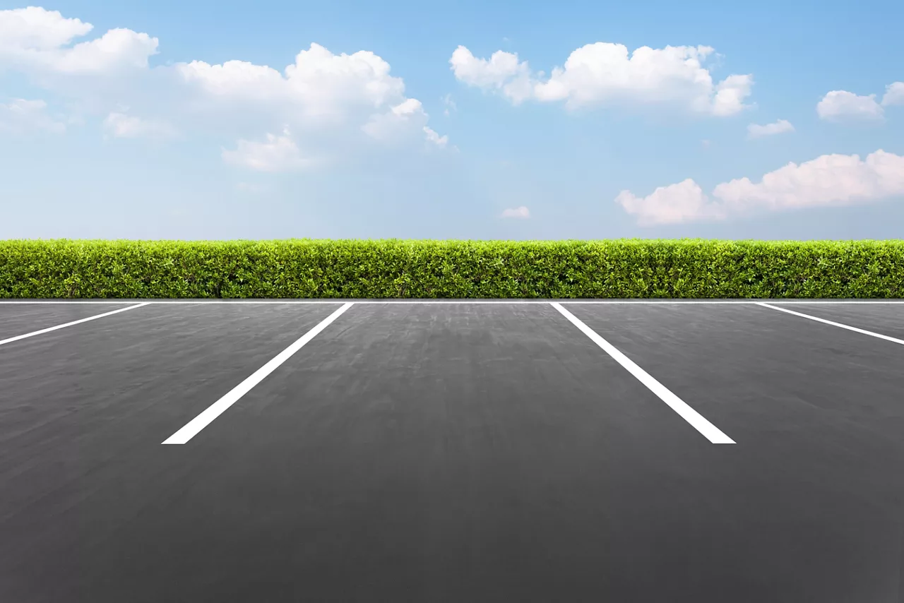 Empty parking lot in the park with blue sky background