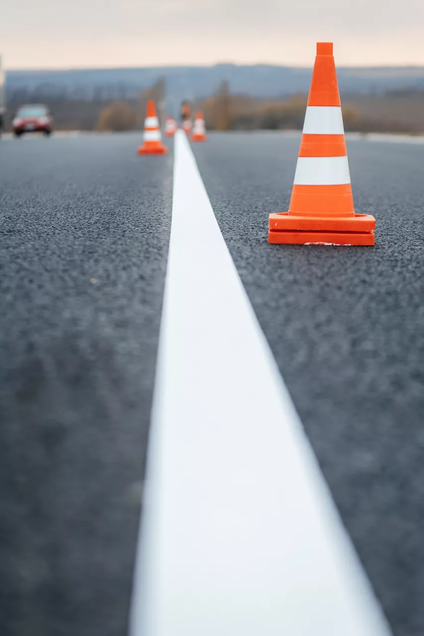 Fresh road markings with orange traffic cones.