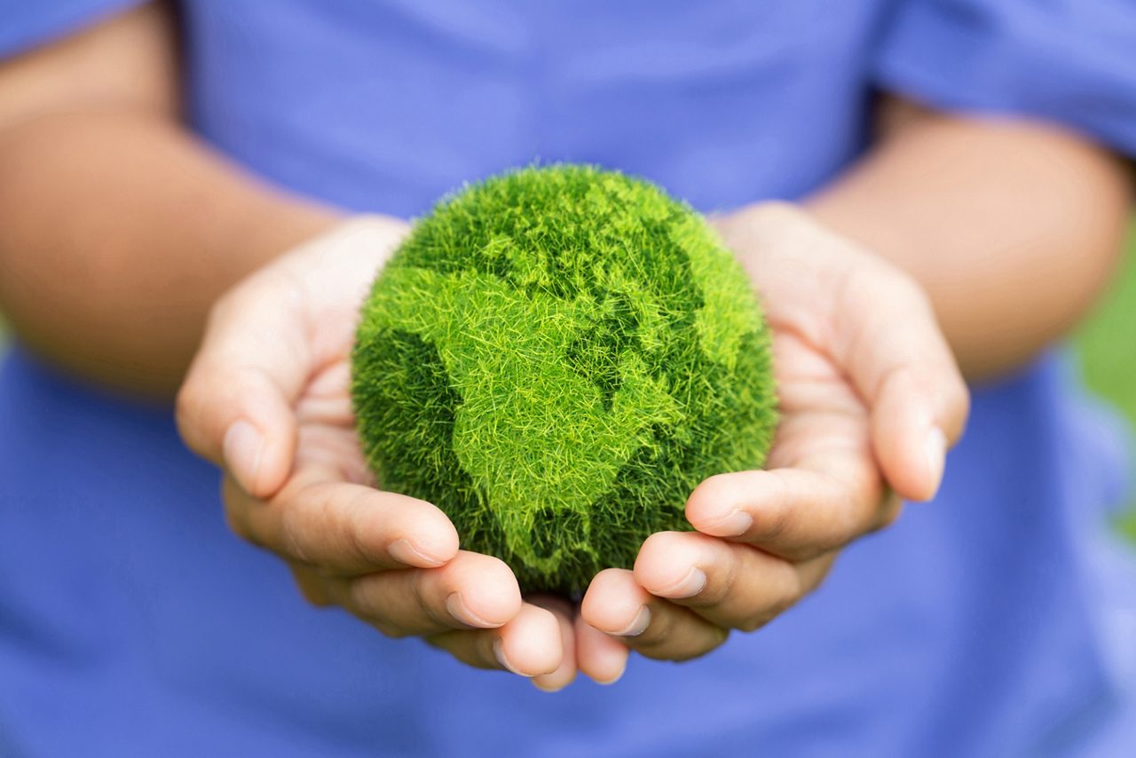 Women hands holding earth on green background. Save and protection Earth.Concept of the environment World Earth Day.