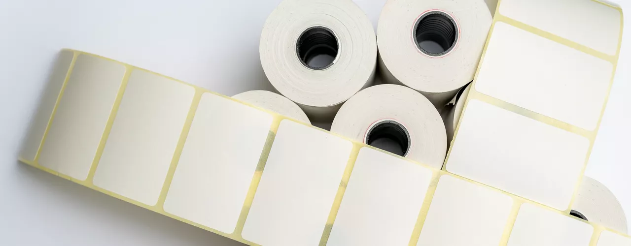 Rolls of white labels isolated. Labels for direct thermal or thermal transfer printing. Blank sticky label roll for thermal transfer printing price criss