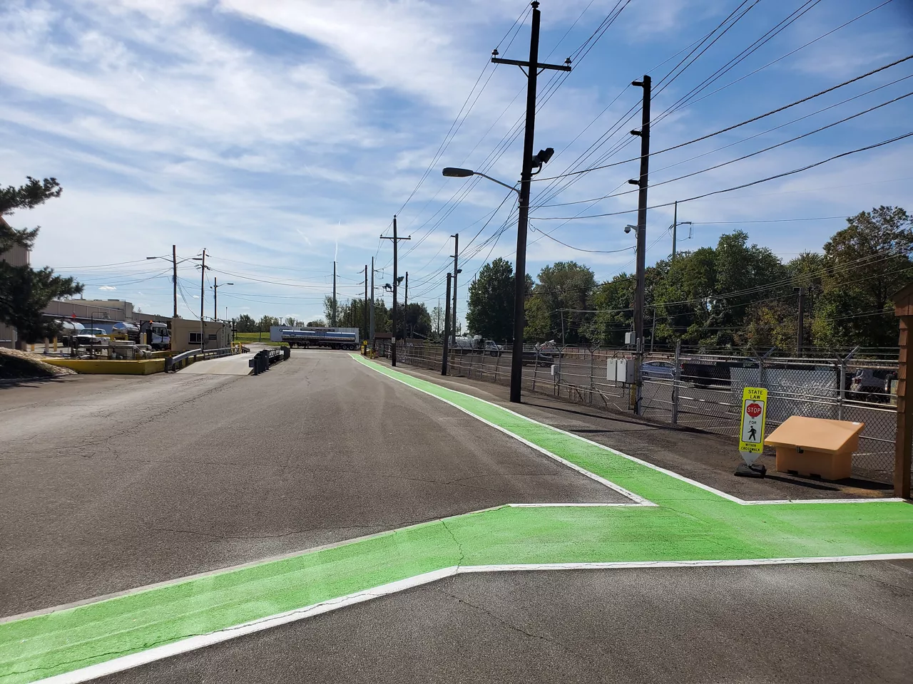 Industrial Wayfinding at Dow Croydon, PA Plant | view of painted green road markings on campus.