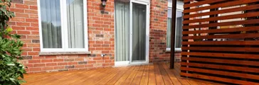 Backyard wooden deck floorboards with fresh brown stain