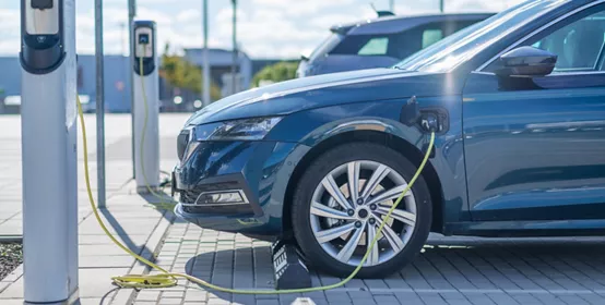 Electric vehicle charging at a station