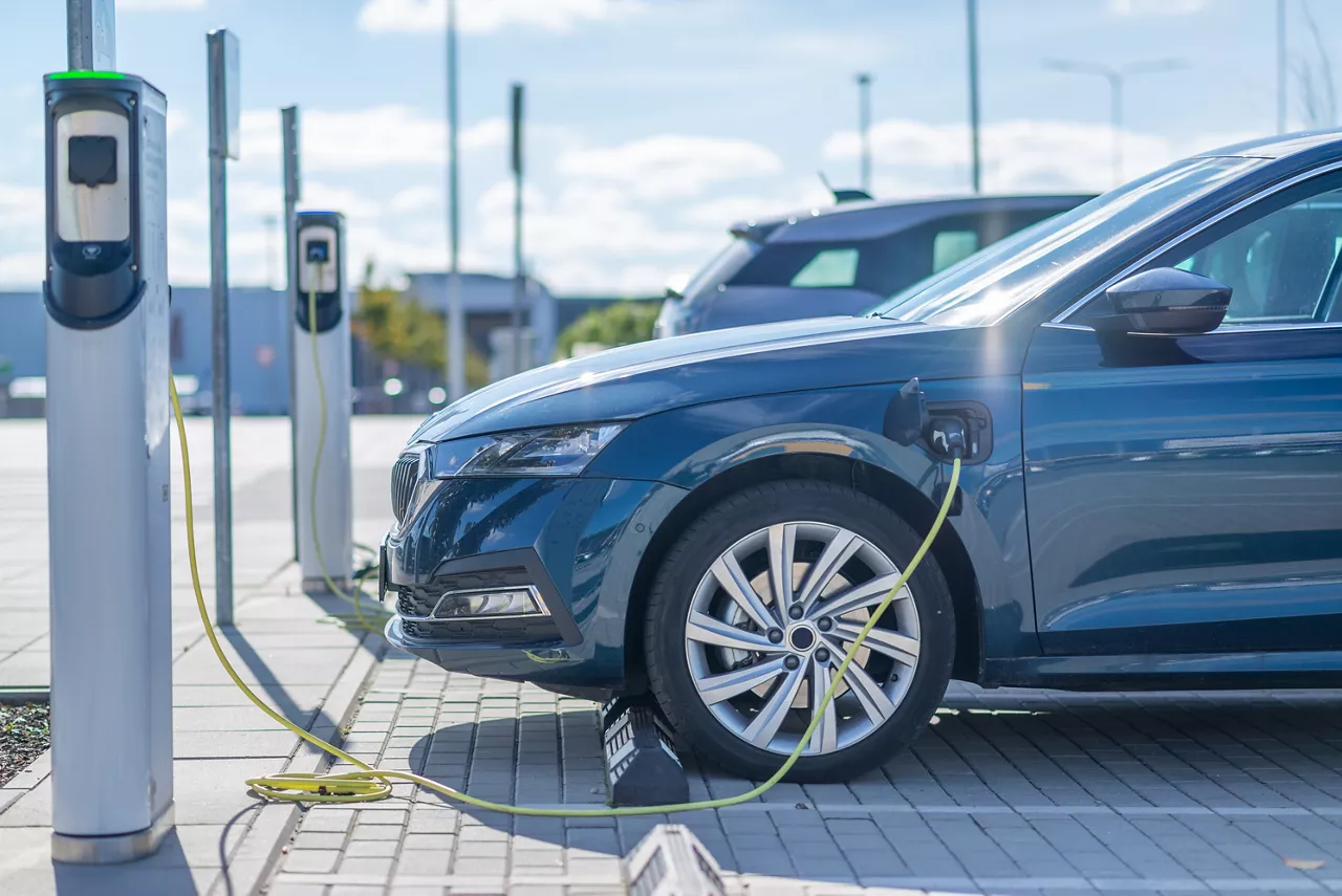 Electric vehicle charging at a station