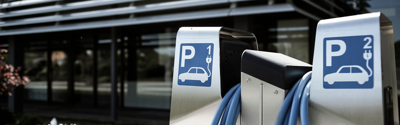 Two electric charging stations outside an office building