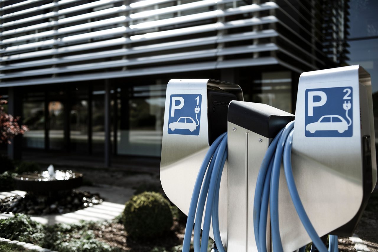 Two electric charging stations outside an office building