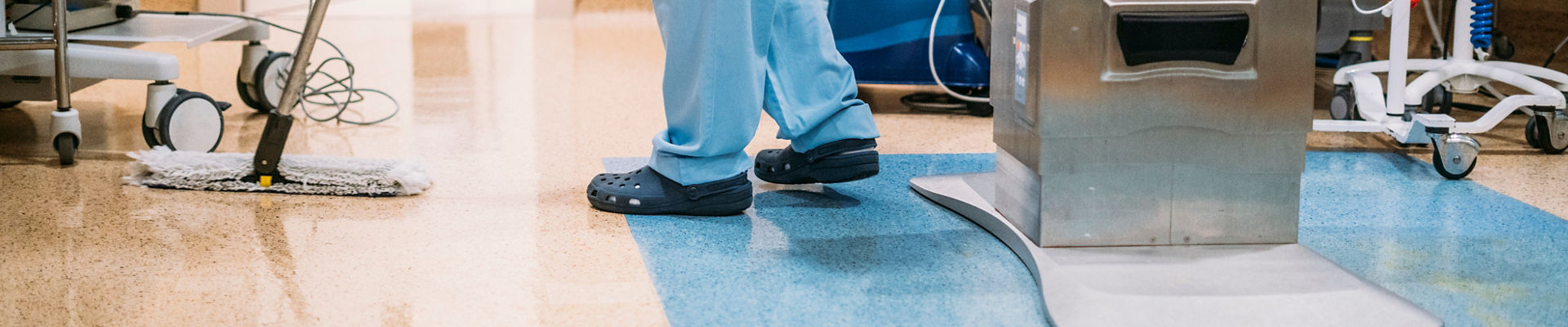 Hospital cleaning staff mopping the floor of hospital operating room