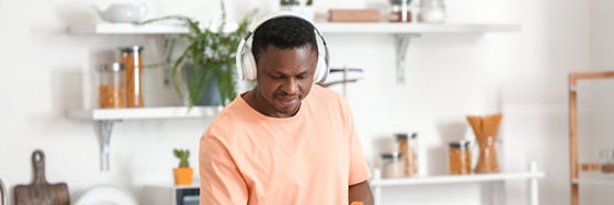 homem ouvindo música enquanto limpa a cozinha