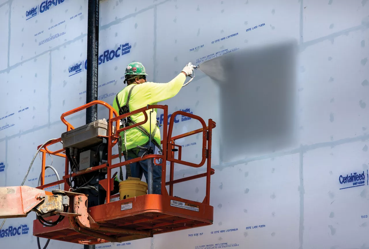 Application of sealant product on building exterior.
