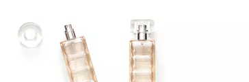 Two transparent perfume bottles isolated on white background