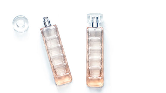 Two perfume bottles, transparent glass spray and bottle cap isolated on white background | K2025 color edit