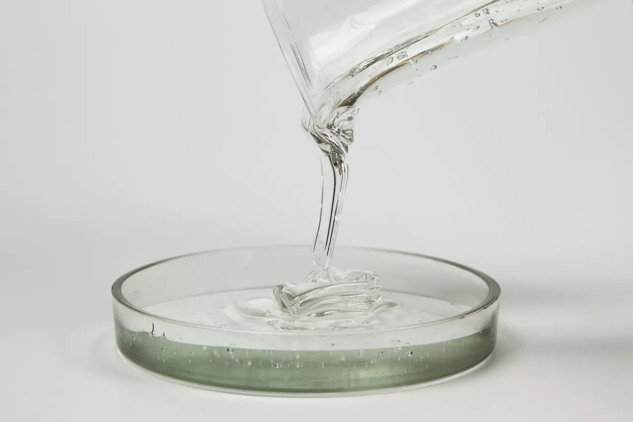 Macro shot of glue or streaming light transparent liquid.