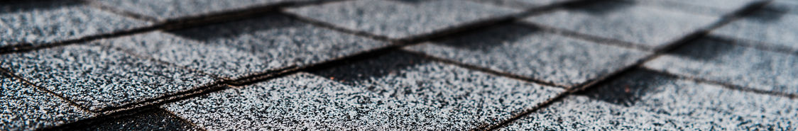 Grey shingles on a building rooftop 