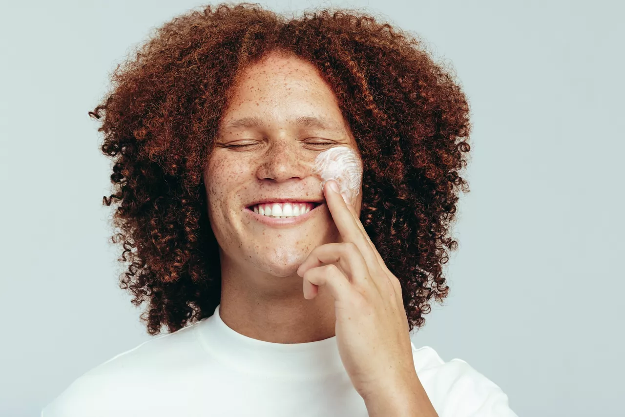 Man taking care of his skin with face cream