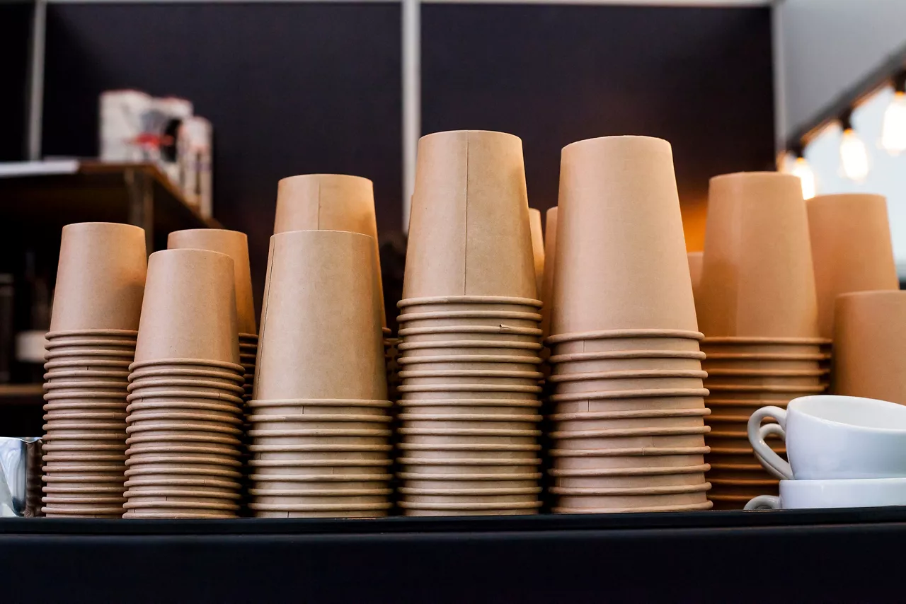 Lot of drinking paper coffee cups in piles. Stack of disposable coffee cup