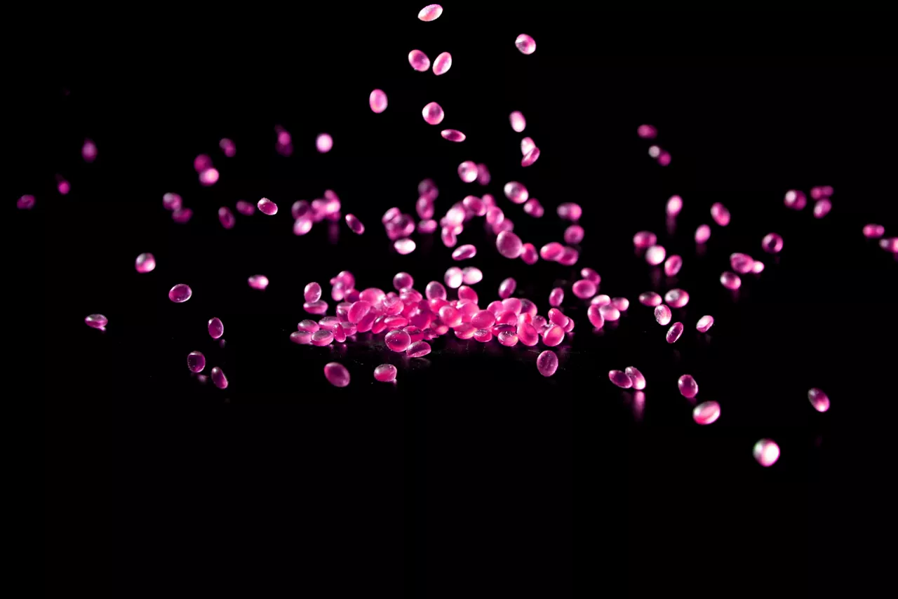Pink aroma beads on black background 