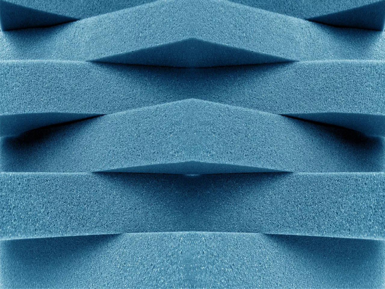 Blue foam strips stacked crosswise.