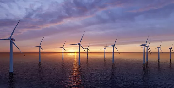 Offshore Wind Turbines Farm at sunset