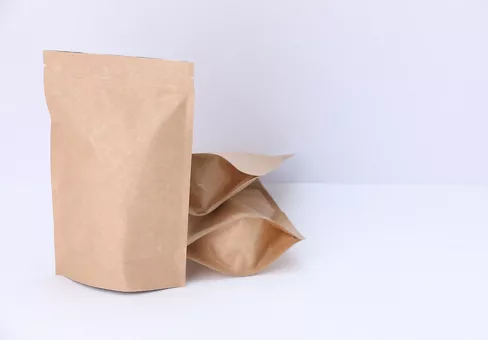 Brown paper stand-up pouches on white background