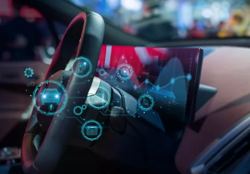 Close-up of a high-tech electric vehicle dashboard featuring a digital interface, futuristic HUD graphics, and smart driving analytics.